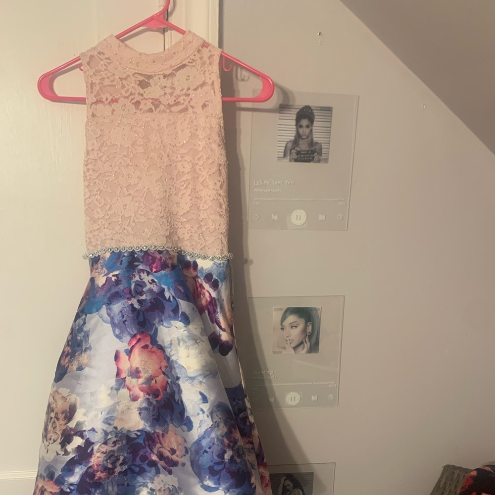 Pink top, purple skirt with multiple color flowers on it, size 14 kids